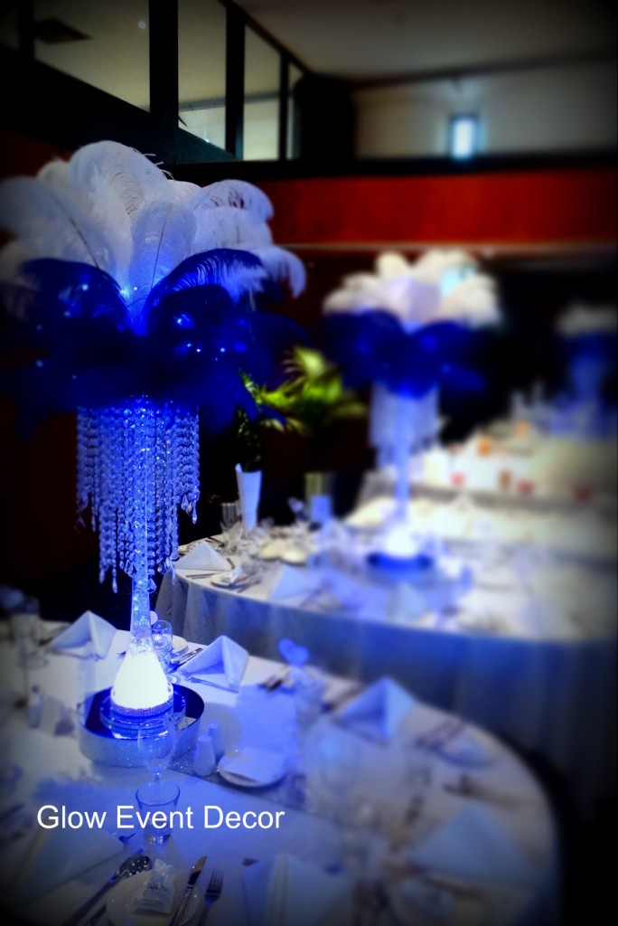 Ostrich feather LED table centrepieces with crystal chandelier drops.